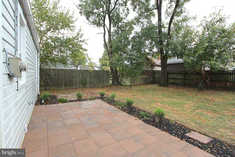 8129 Bullneck Road Baltimore, MD 21222 - Photo 28 of 30 a view of a backyard with plants and large tree