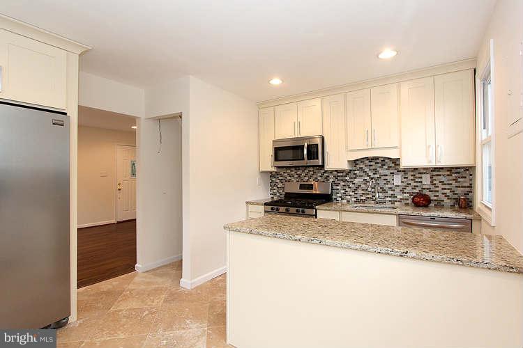 8129 Bullneck Road Baltimore, MD 21222 - Photo 5 of 30 a kitchen with stainless steel appliances granite countertop a refrigerator a stove and a sink