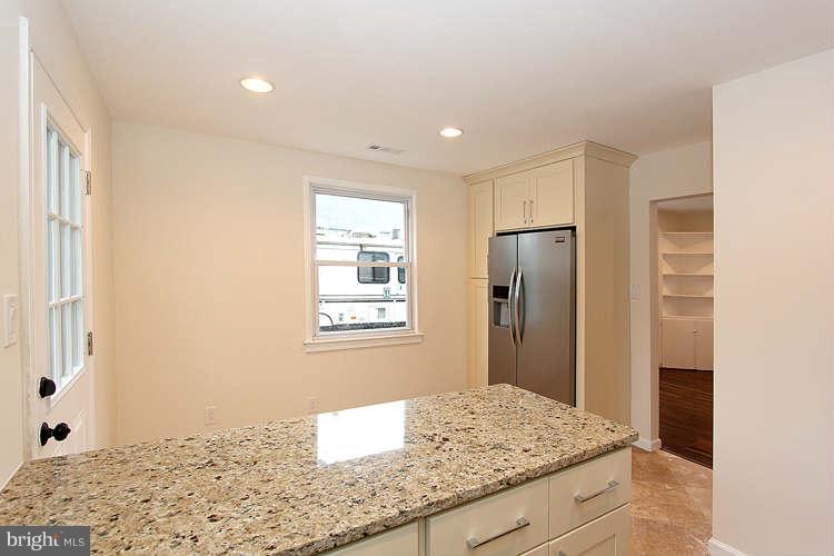 8129 Bullneck Road Baltimore, MD 21222 - Photo 8 of 30 a bathroom with a granite countertop sink and a mirror