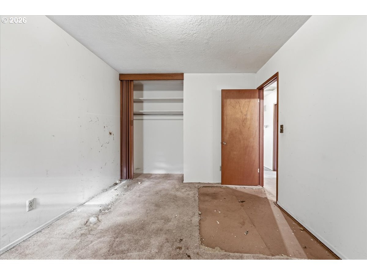 12333 Southeast Madison Street Portland, OR 97233 - Photo 20 of 28 a view of an empty room with closet and a window