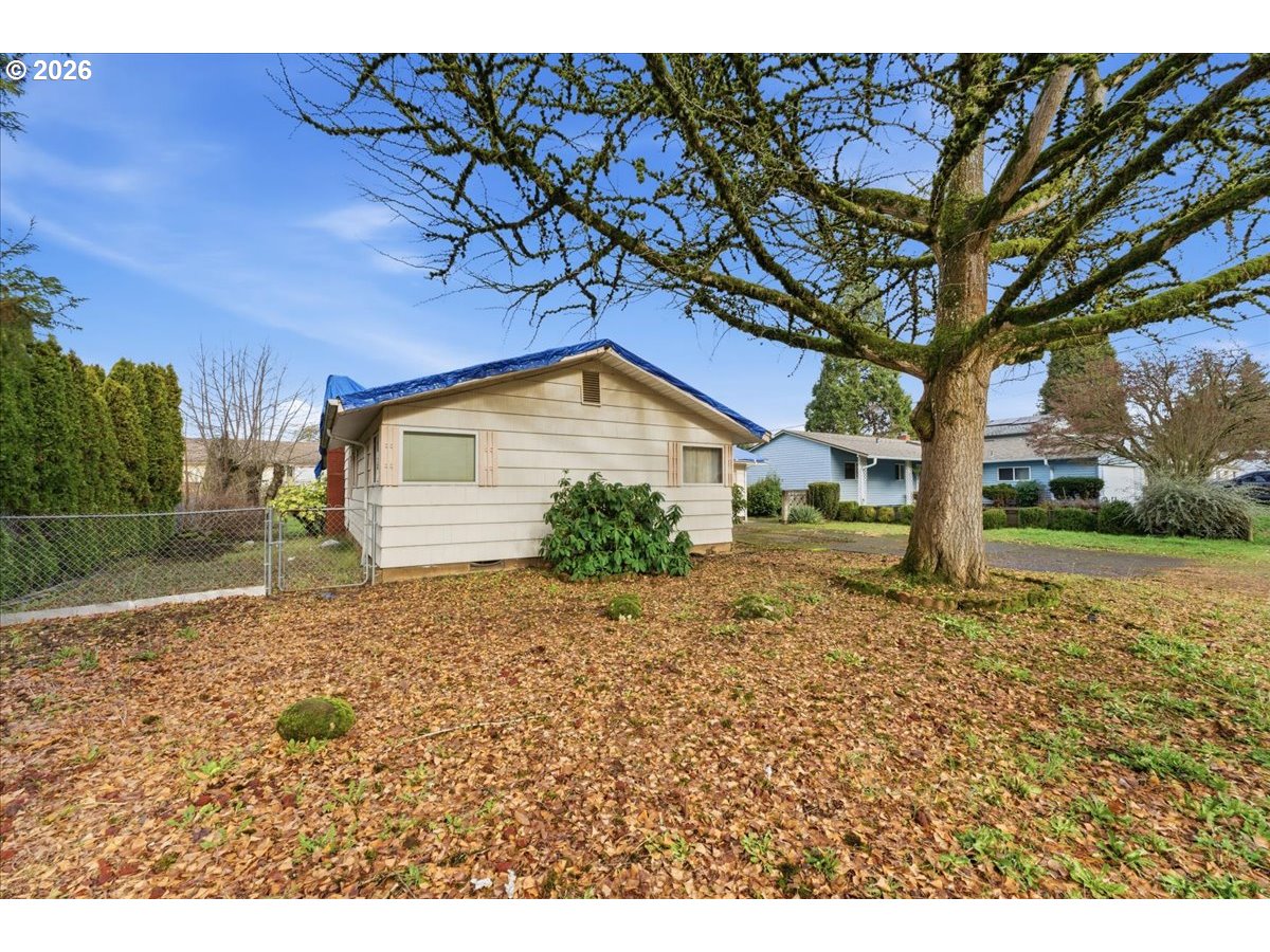 12333 Southeast Madison Street Portland, OR 97233 - Photo 3 of 28 a backyard of a house with lots of green space