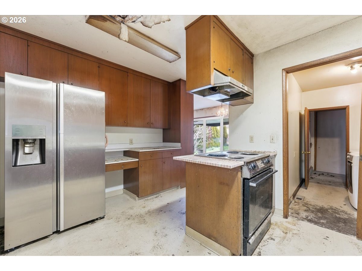 12333 Southeast Madison Street Portland, OR 97233 - Photo 4 of 28 a kitchen with stainless steel appliances granite countertop a stove a refrigerator and a sink