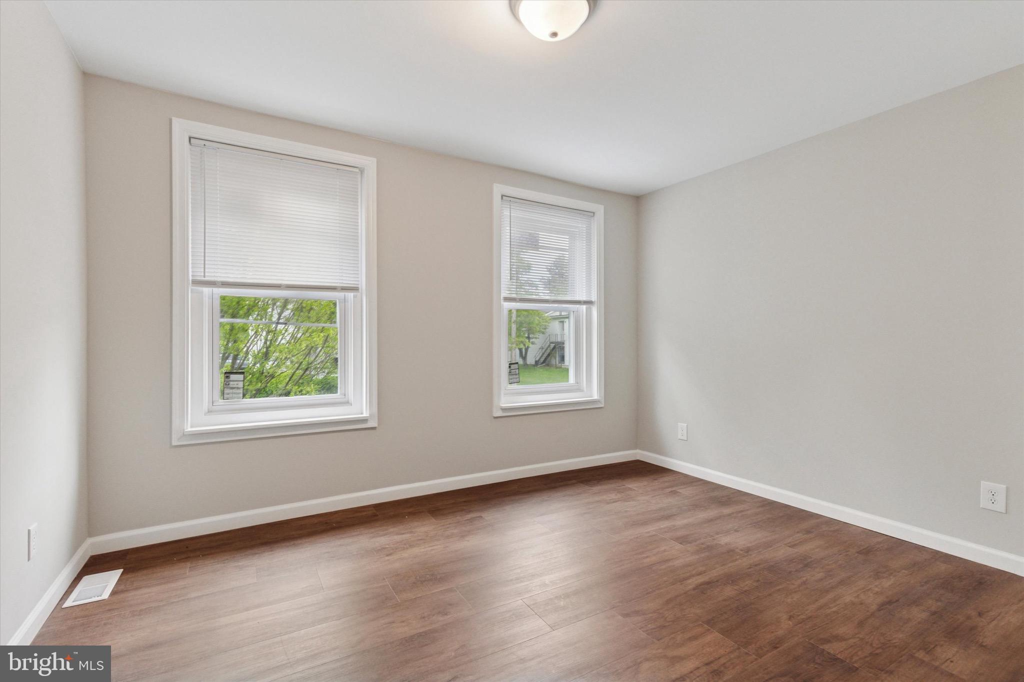232 Main Street Hellertown, PA 18055 - Photo 6 of 13 an empty room with wooden floor and windows