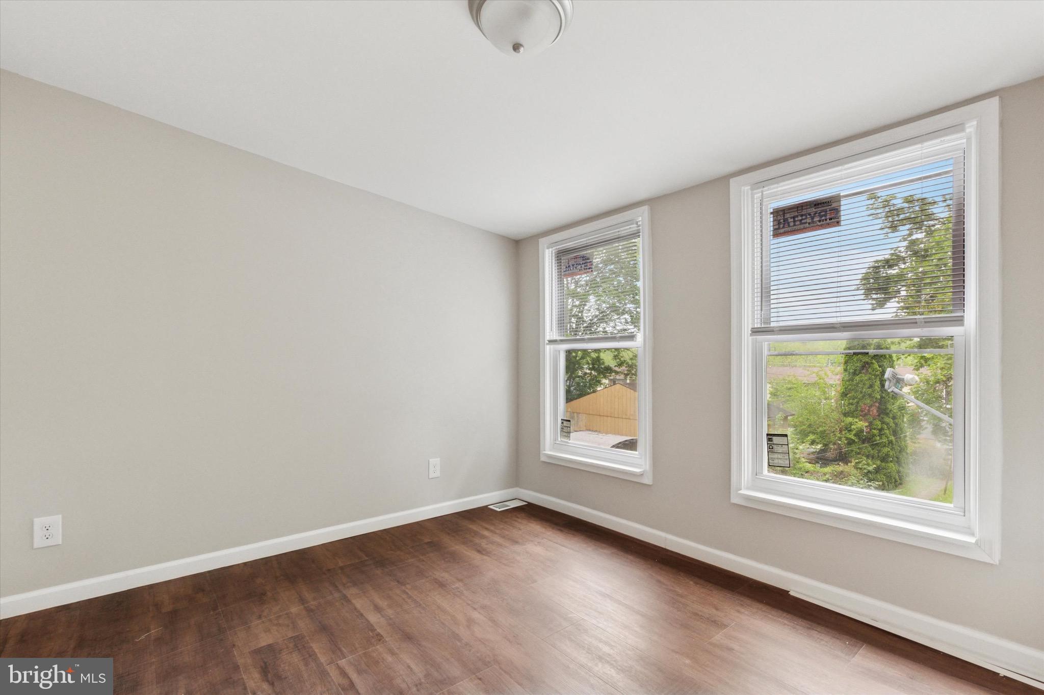 232 Main Street Hellertown, PA 18055 - Photo 10 of 13 an empty room with wooden floor and windows