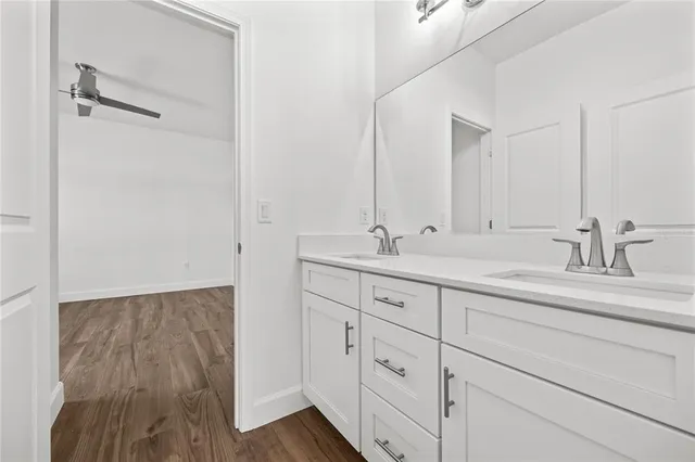 a bathroom with double vanity sink and a mirror