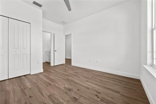 a view of an empty room with wooden floor