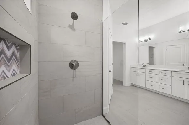 a bathroom with a double vanity sink a mirror a shower and vanity