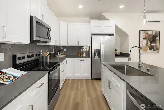 a kitchen with a sink stove top oven and refrigerator