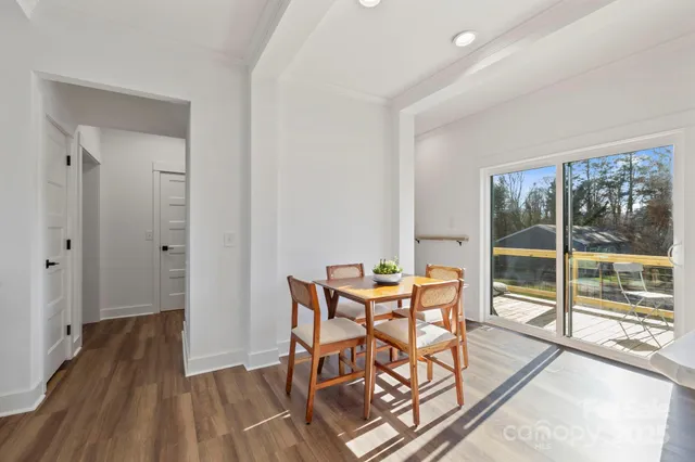 a view of a room with furniture and wooden floor
