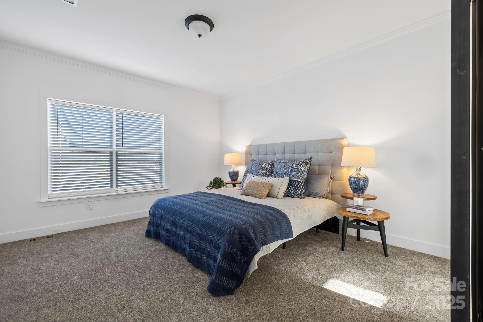 205 Southern Charm Road Arden, NC 28704 - Photo 12 of 26 a bedroom with a bed and a window