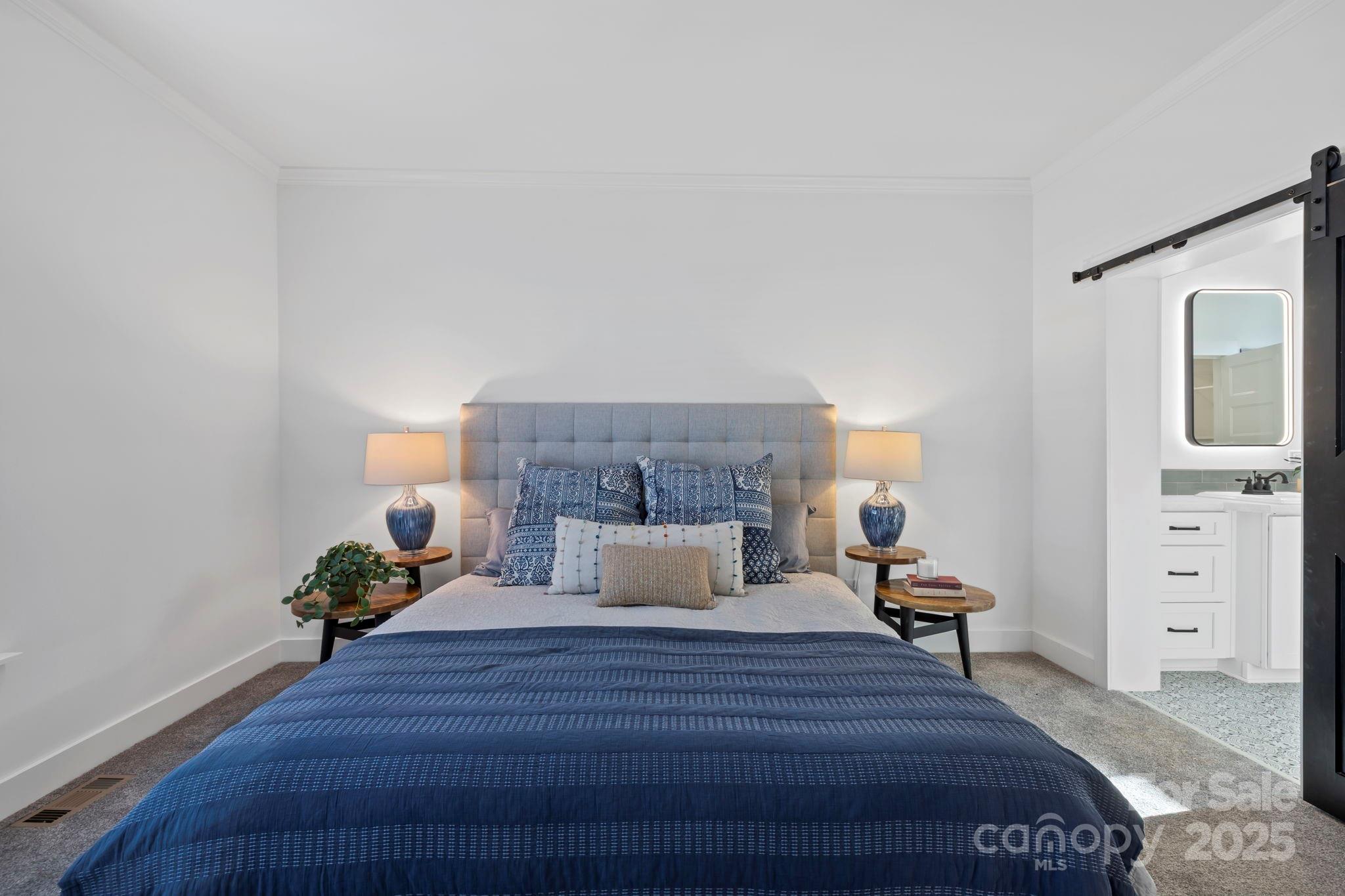 205 Southern Charm Road Arden, NC 28704 - Photo 13 of 26 a bedroom with a bed and wooden floor