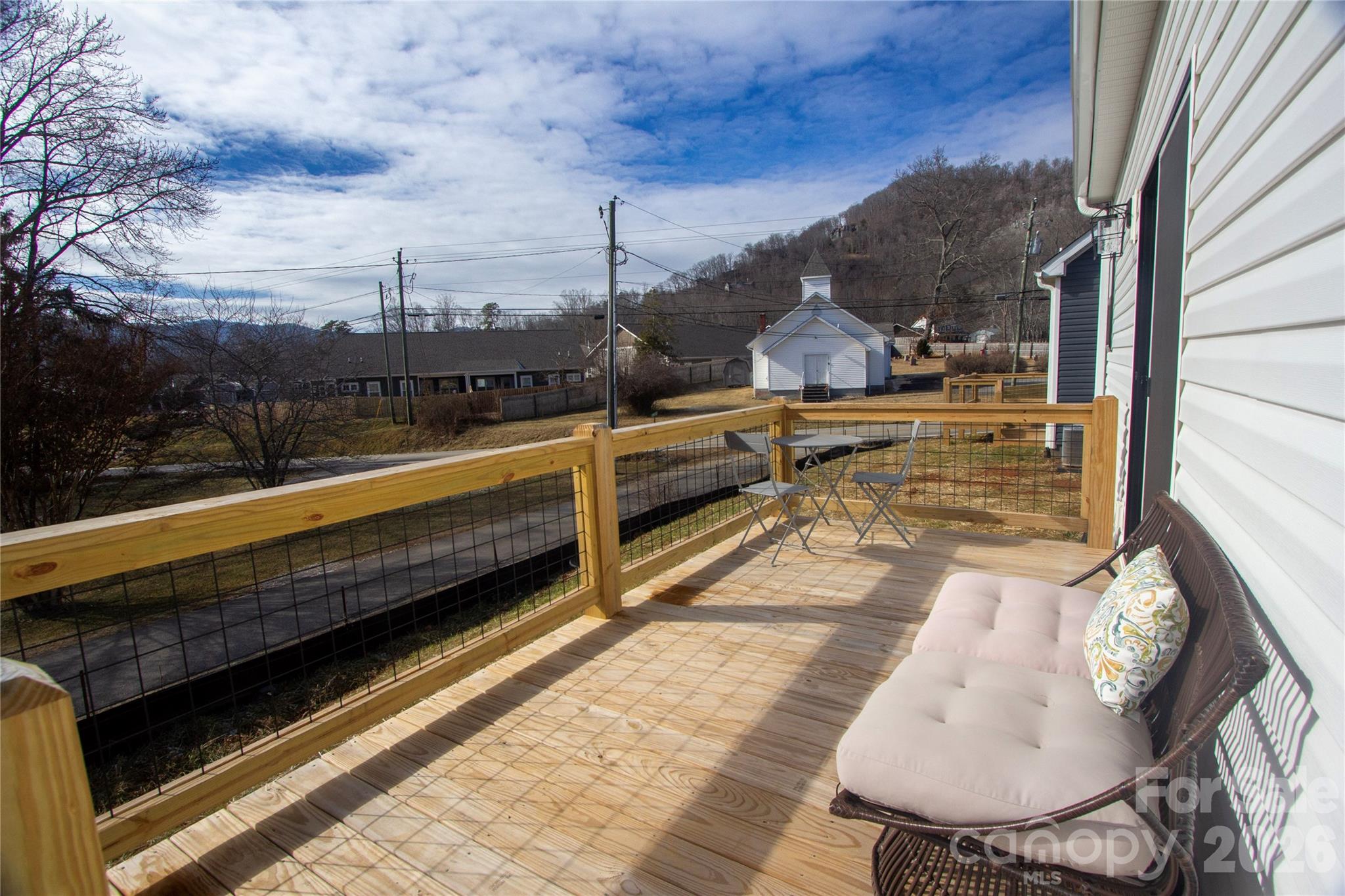 205 Southern Charm Road Arden, NC 28704 - Photo 13 of 34 a view of a balcony with two chairs and a table