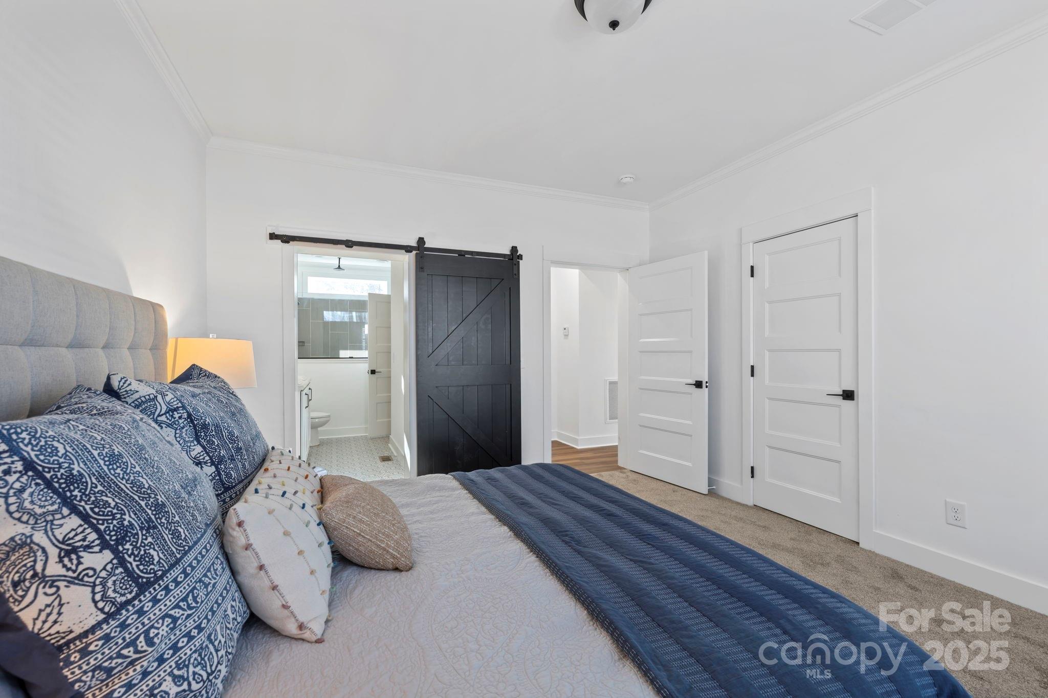 205 Southern Charm Road Arden, NC 28704 - Photo 14 of 26 a bedroom with a large bed and wooden floor