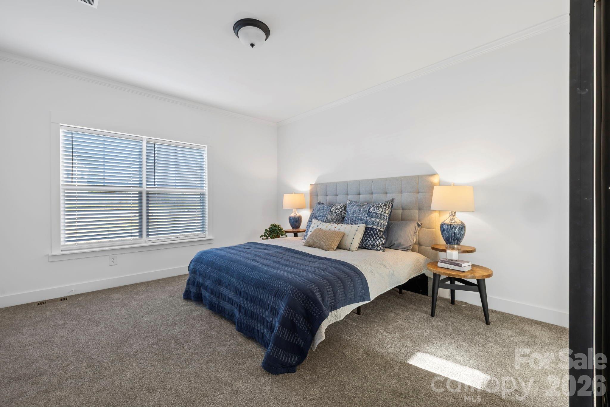 205 Southern Charm Road Arden, NC 28704 - Photo 14 of 34 a bedroom with a bed and a window