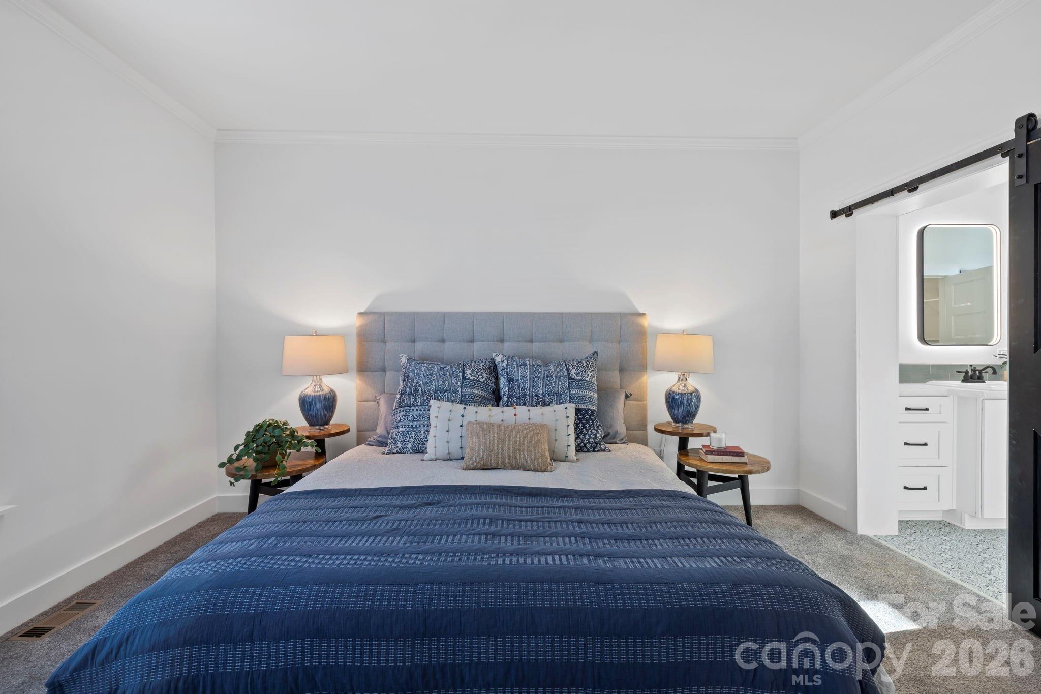 205 Southern Charm Road Arden, NC 28704 - Photo 15 of 34 a bedroom with a bed and wooden floor