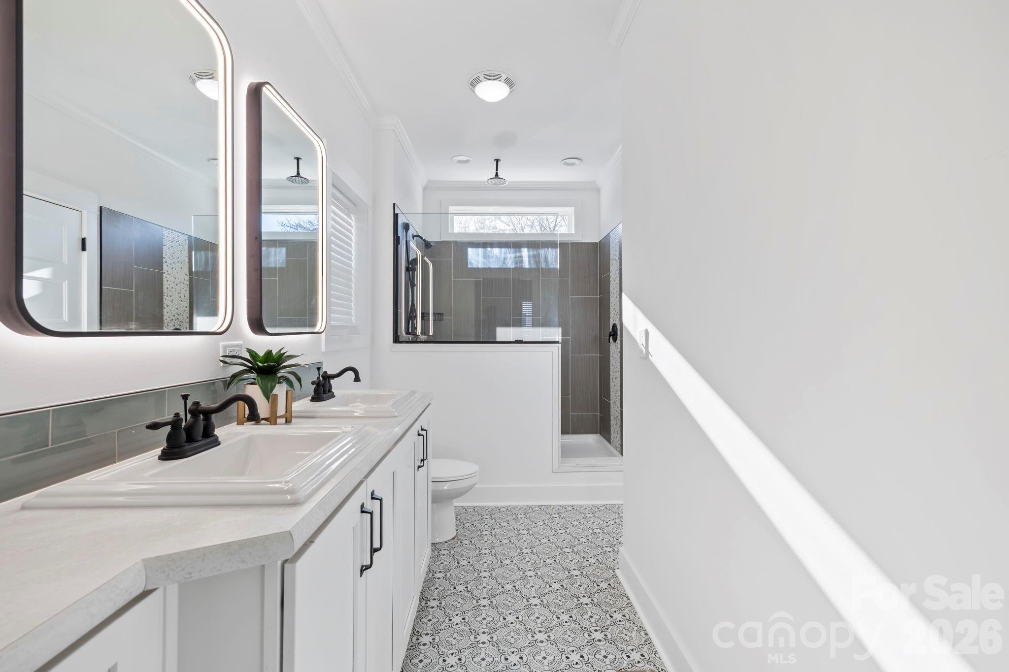 205 Southern Charm Road Arden, NC 28704 - Photo 17 of 34 a bathroom with a double vanity sink and a mirror
