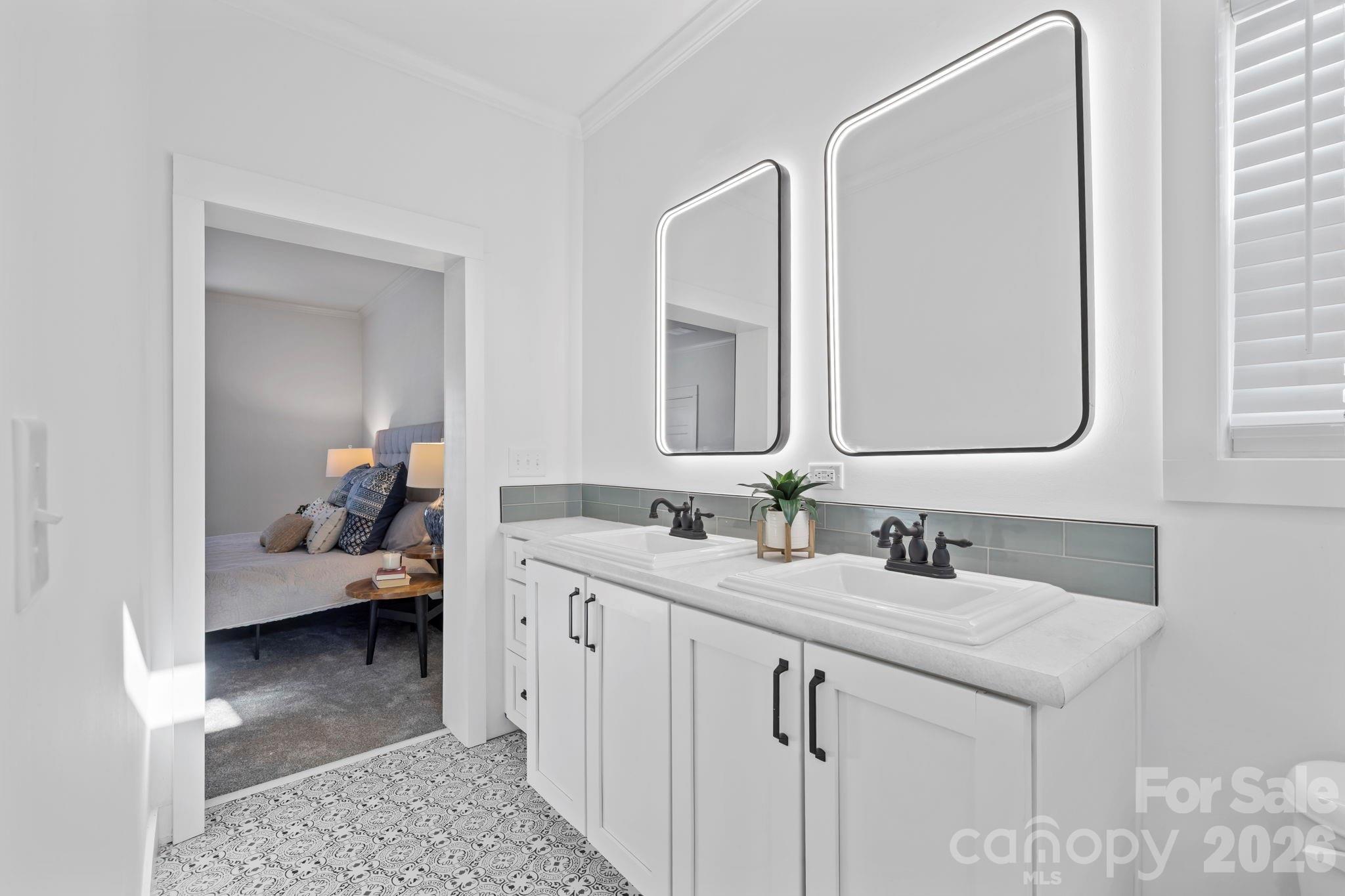 205 Southern Charm Road Arden, NC 28704 - Photo 19 of 34 a en suite bathroom with a double vanity sink and a mirror