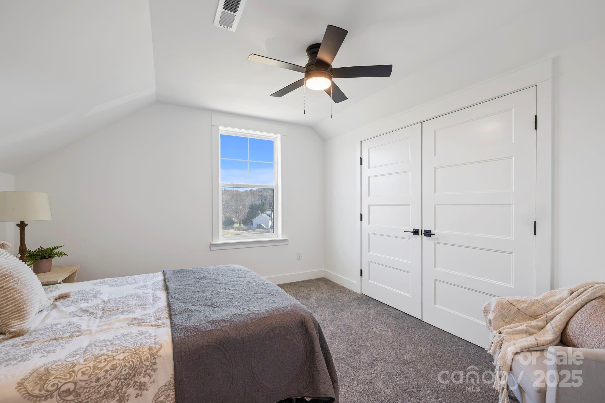 205 Southern Charm Road Arden, NC 28704 - Photo 20 of 26 a bedroom with a bed and a chandelier fan