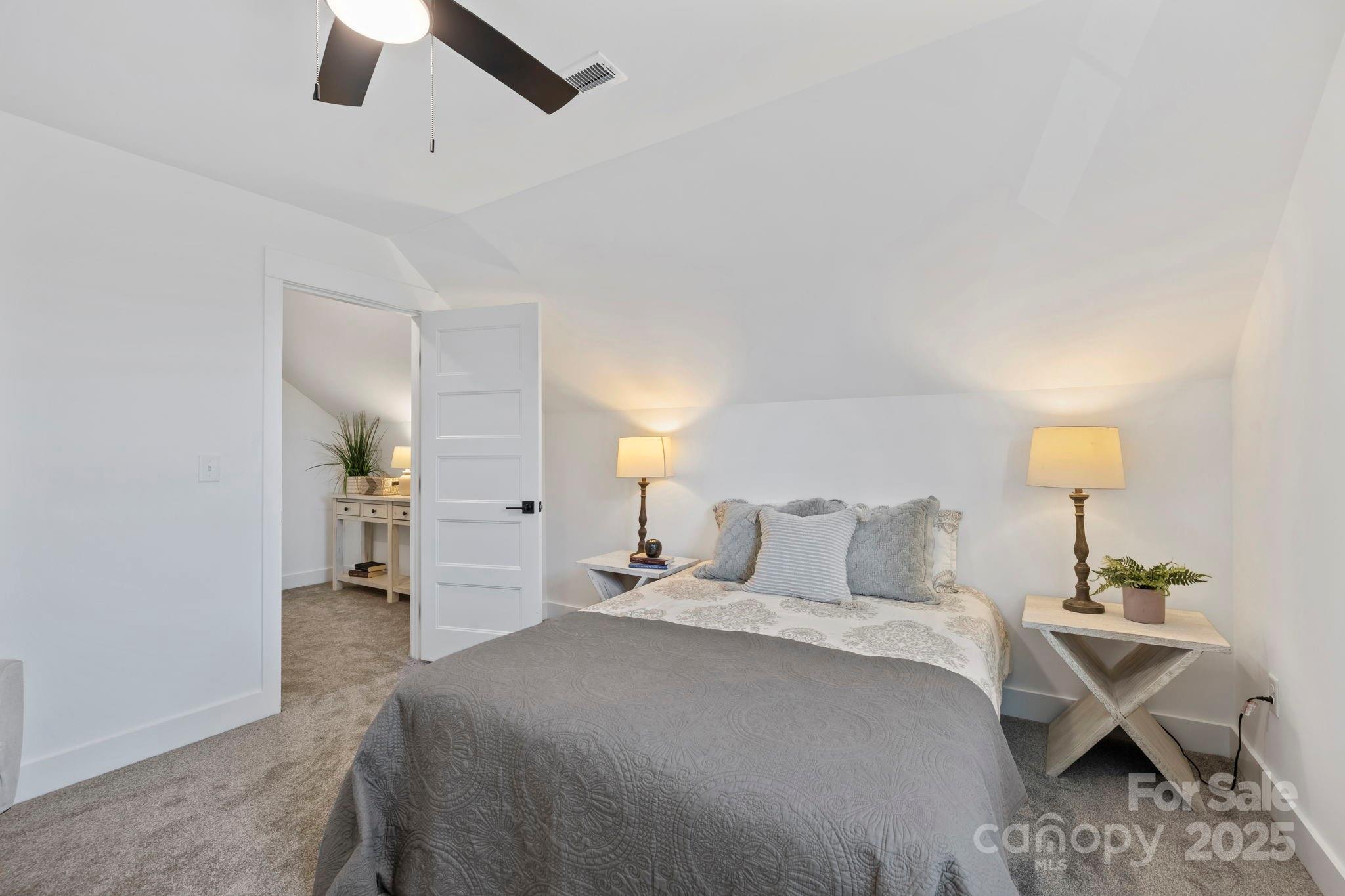 205 Southern Charm Road Arden, NC 28704 - Photo 21 of 26 a bedroom with a bed and a lamp on table