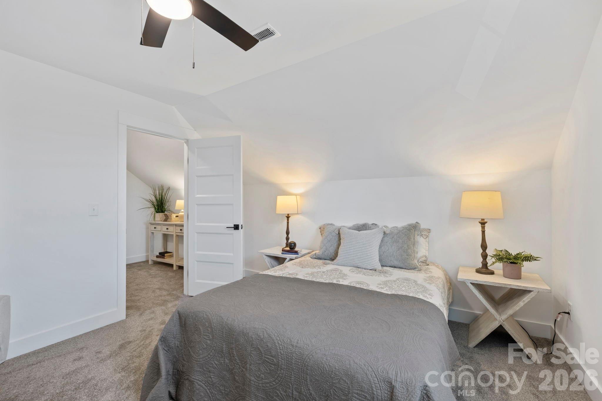 205 Southern Charm Road Arden, NC 28704 - Photo 23 of 34 a bedroom with a bed and a lamp on table