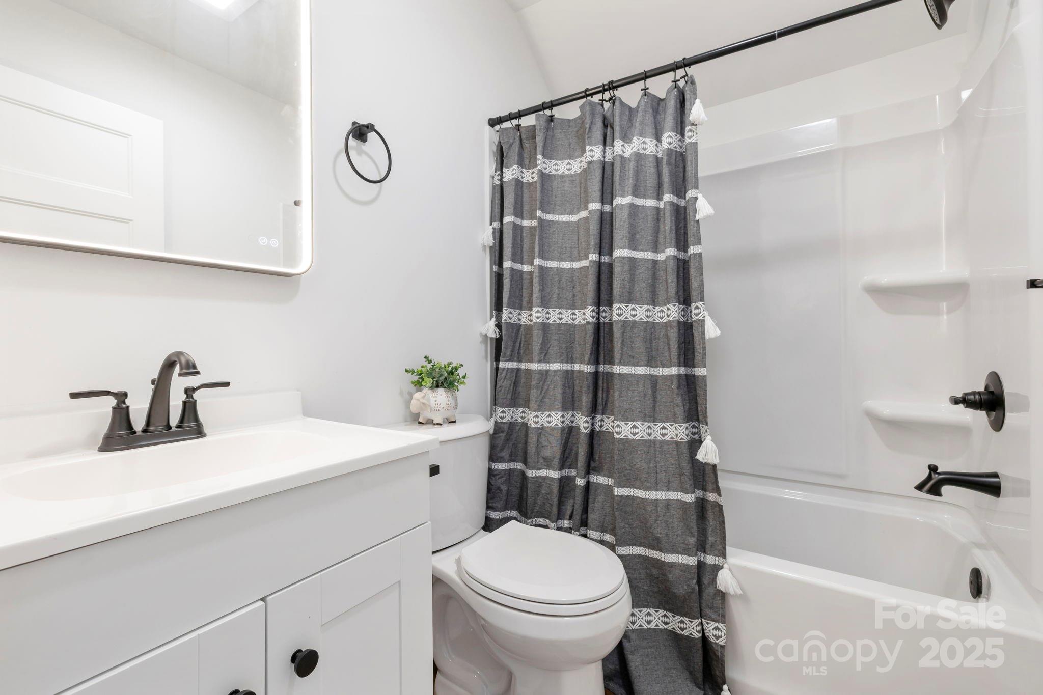 205 Southern Charm Road Arden, NC 28704 - Photo 23 of 26 a bathroom with a sink toilet and shower