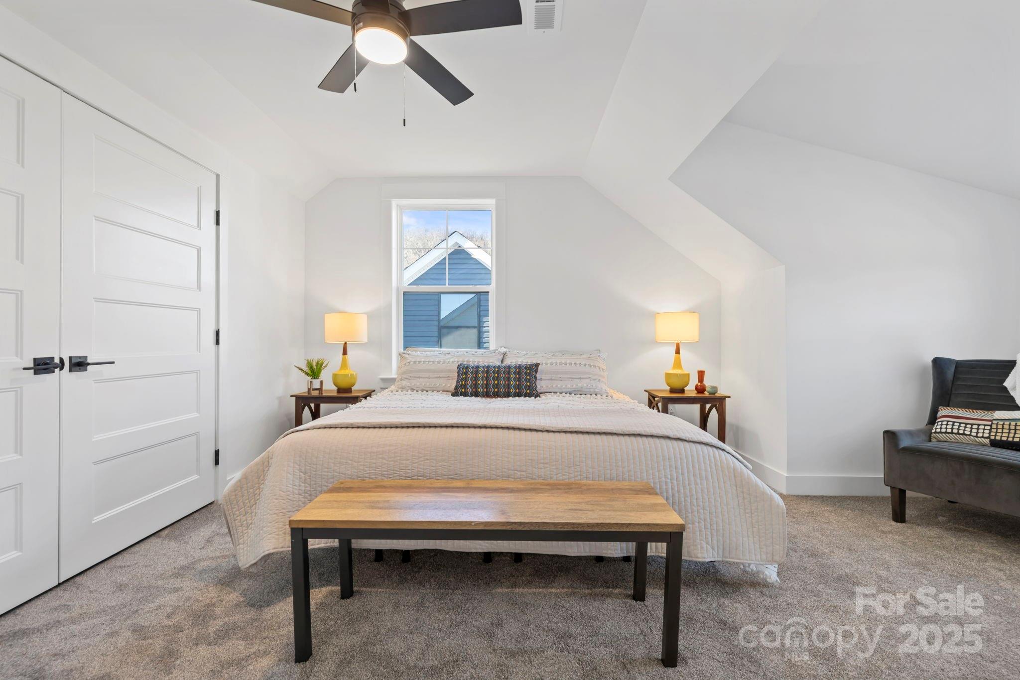 205 Southern Charm Road Arden, NC 28704 - Photo 24 of 26 a bedroom with a bed and a chandelier