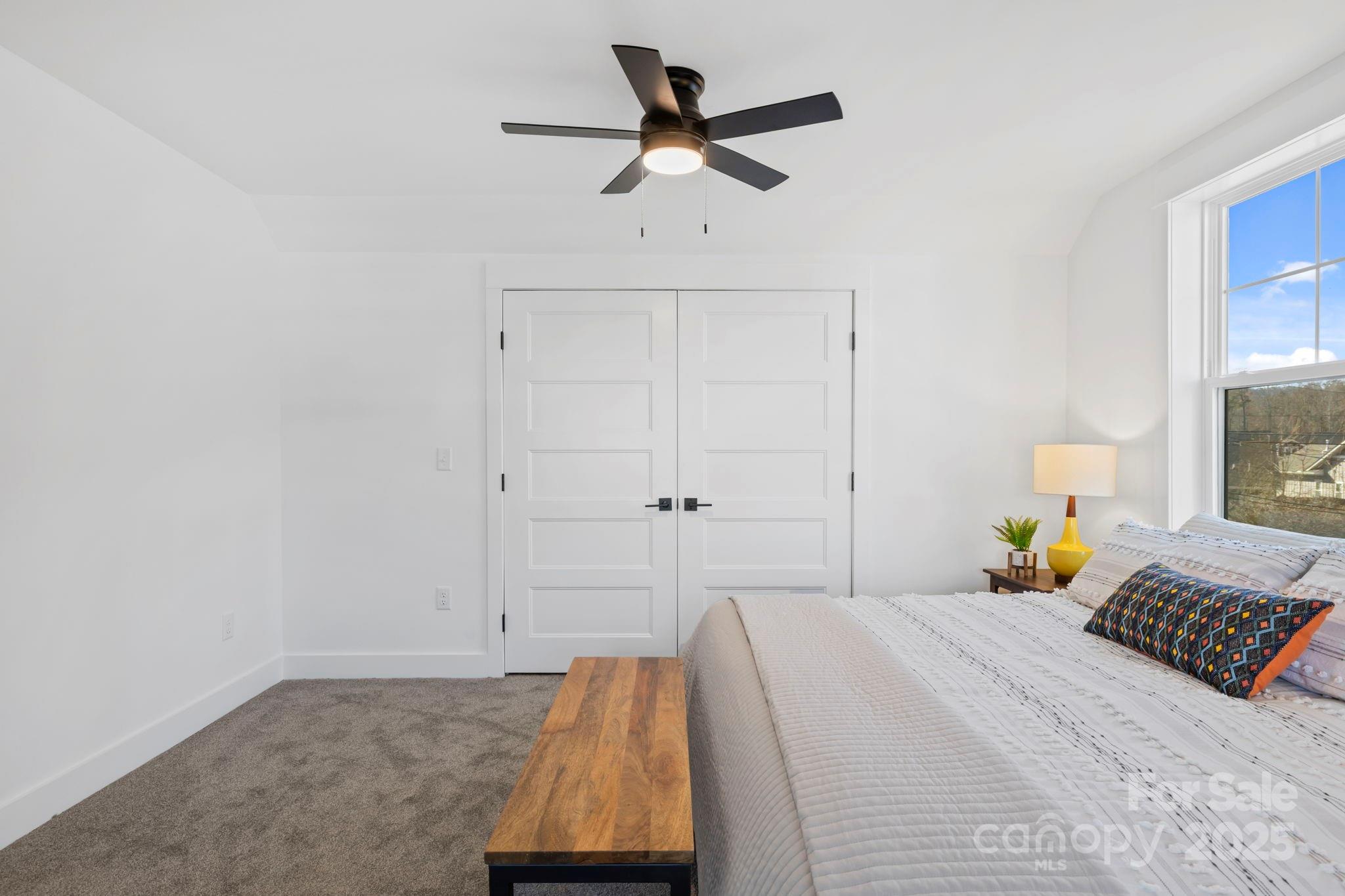 205 Southern Charm Road Arden, NC 28704 - Photo 26 of 26 a bedroom with a bed and a chandelier