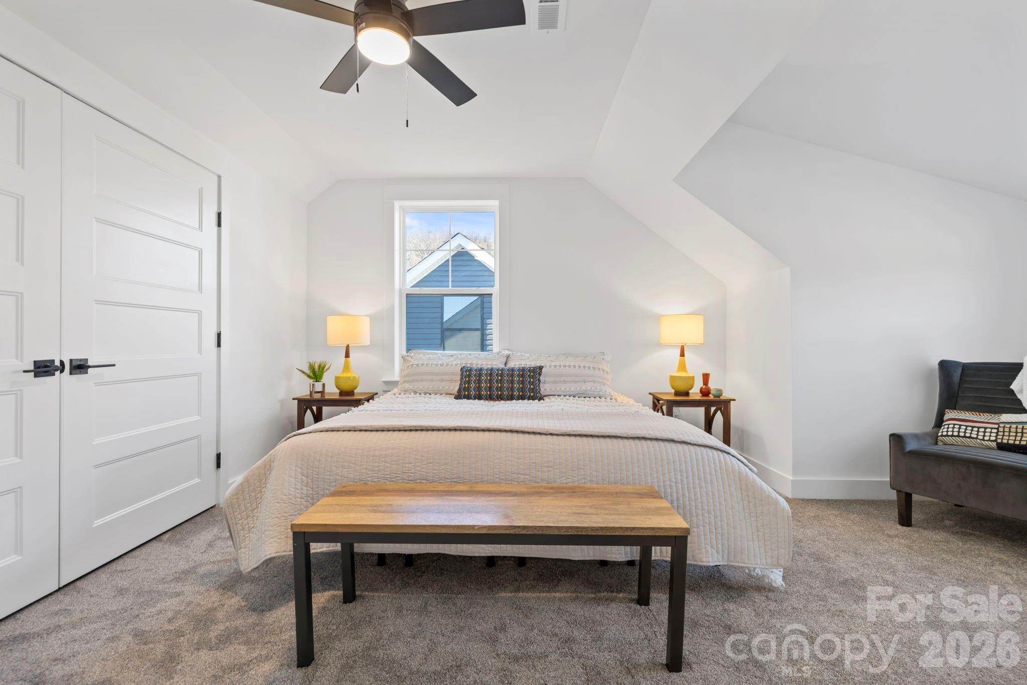 205 Southern Charm Road Arden, NC 28704 - Photo 27 of 34 a bedroom with a bed and a chandelier