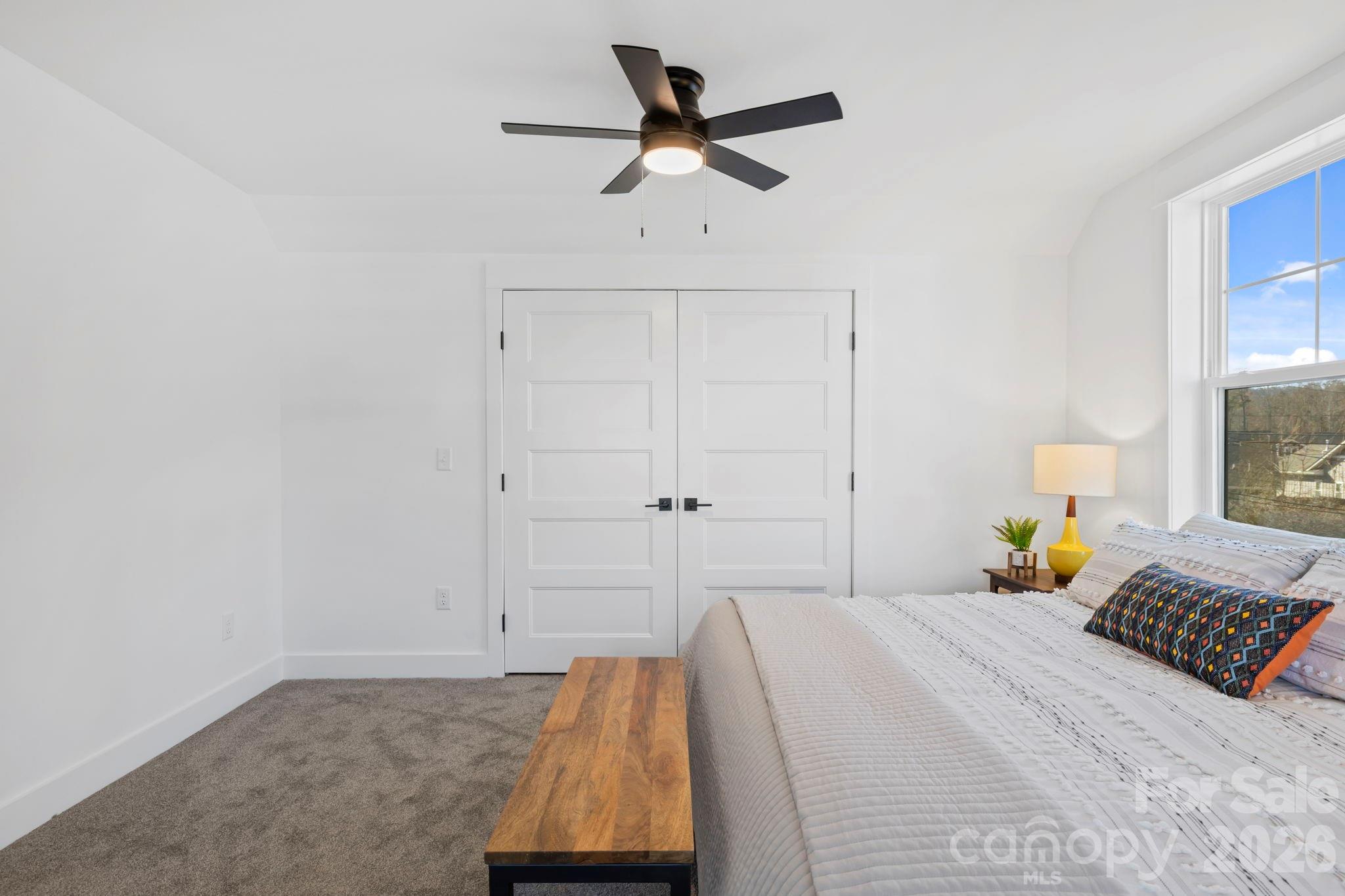 205 Southern Charm Road Arden, NC 28704 - Photo 29 of 34 a bedroom with a bed and a chandelier