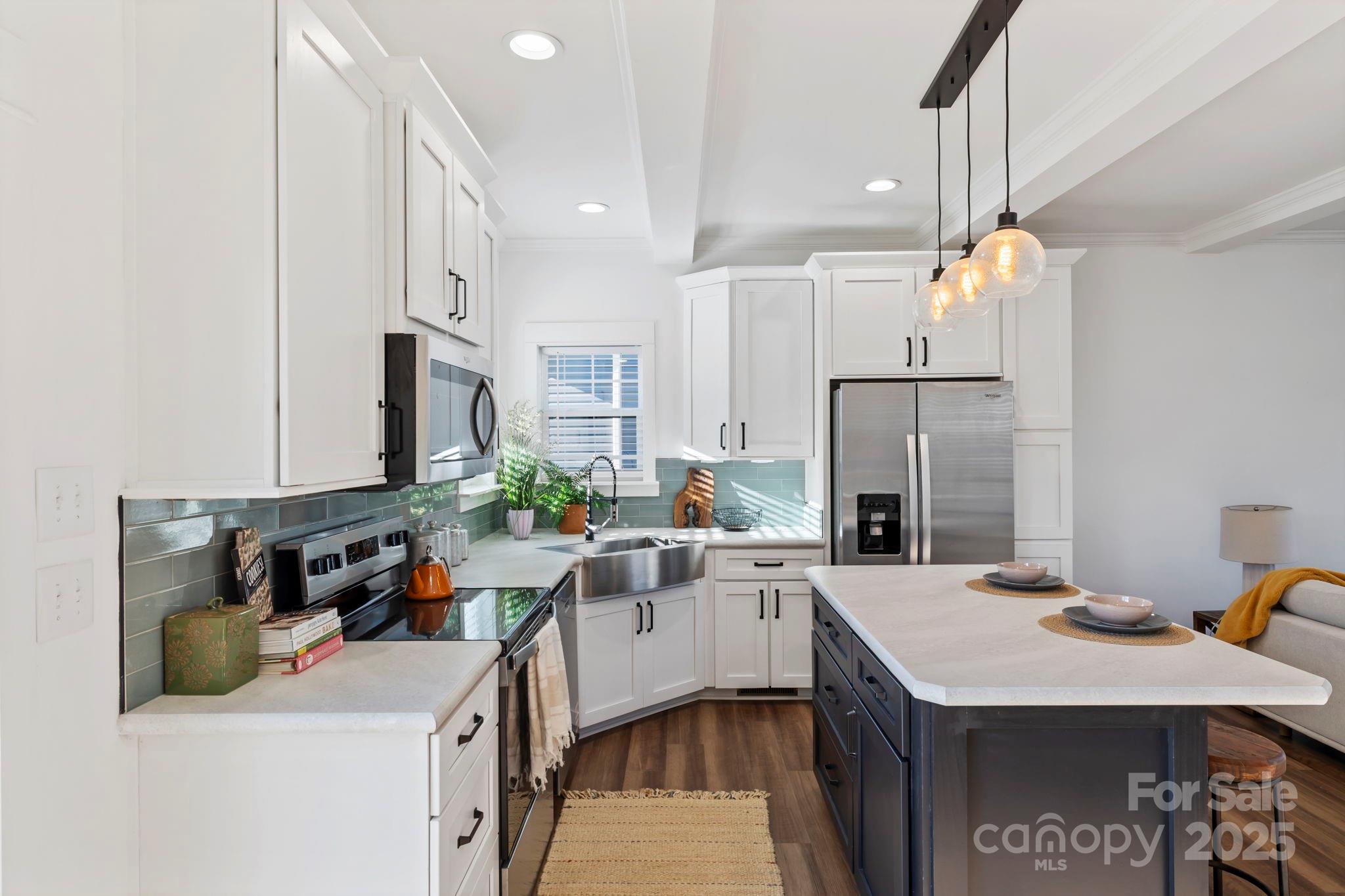 205 Southern Charm Road Arden, NC 28704 - Photo 8 of 26 a kitchen with a sink appliances and cabinets