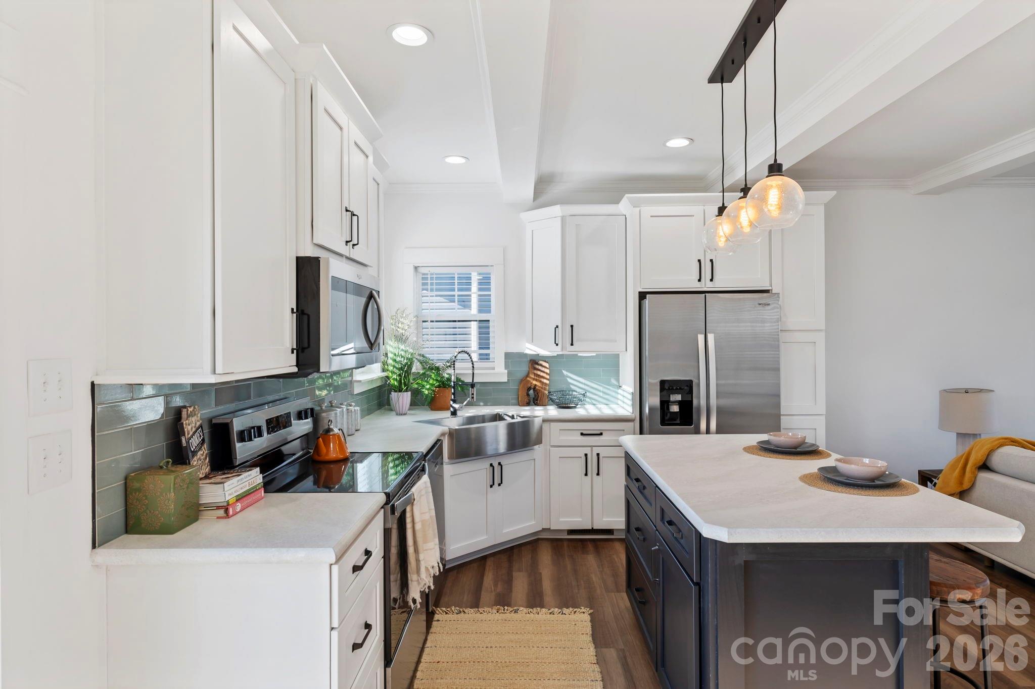 205 Southern Charm Road Arden, NC 28704 - Photo 8 of 34 a kitchen with a sink appliances and cabinets