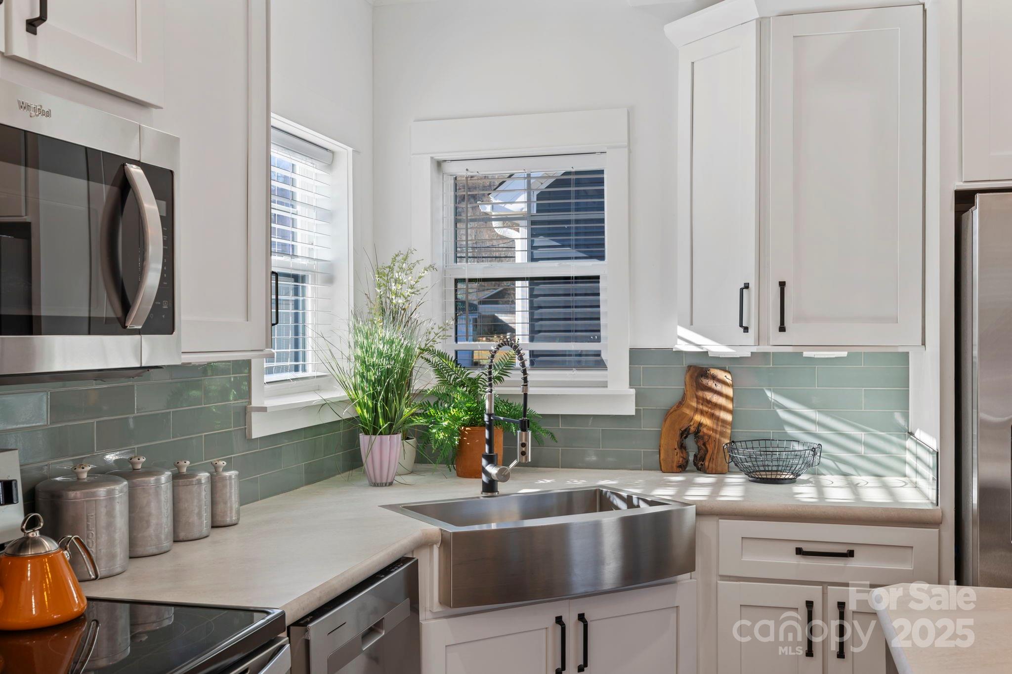 205 Southern Charm Road Arden, NC 28704 - Photo 10 of 26 a kitchen with a table chairs and microwave