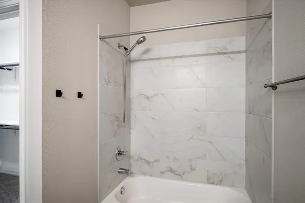 a bathroom that has a glass shower door