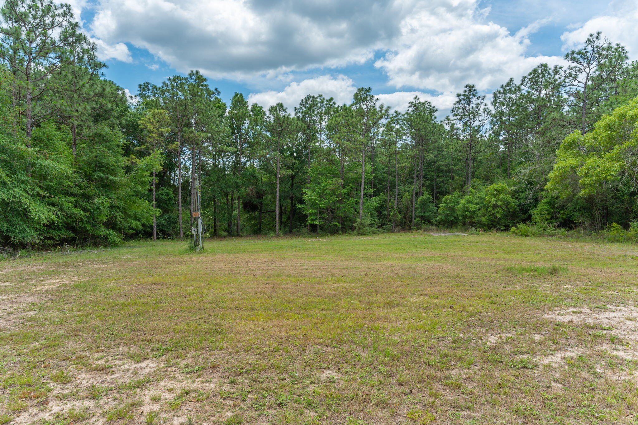 5710 Seminole Drive Crestview, FL 32536 - Photo 11 of 17 a view of a field with trees in the background