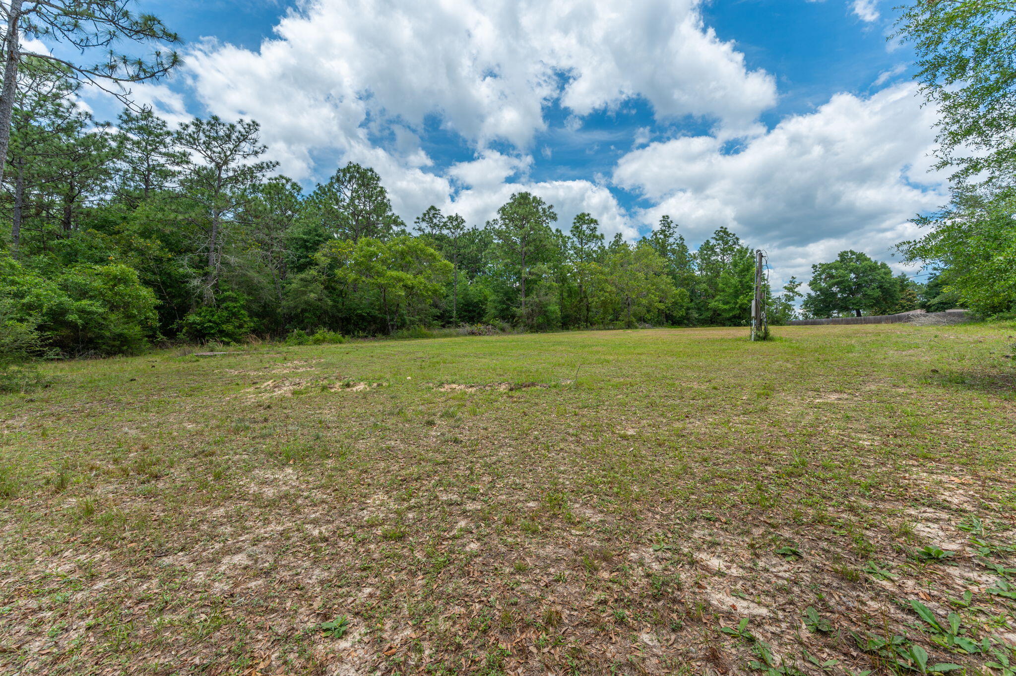 5710 Seminole Drive Crestview, FL 32536 - Photo 12 of 17 a view of a green field with wooden fence