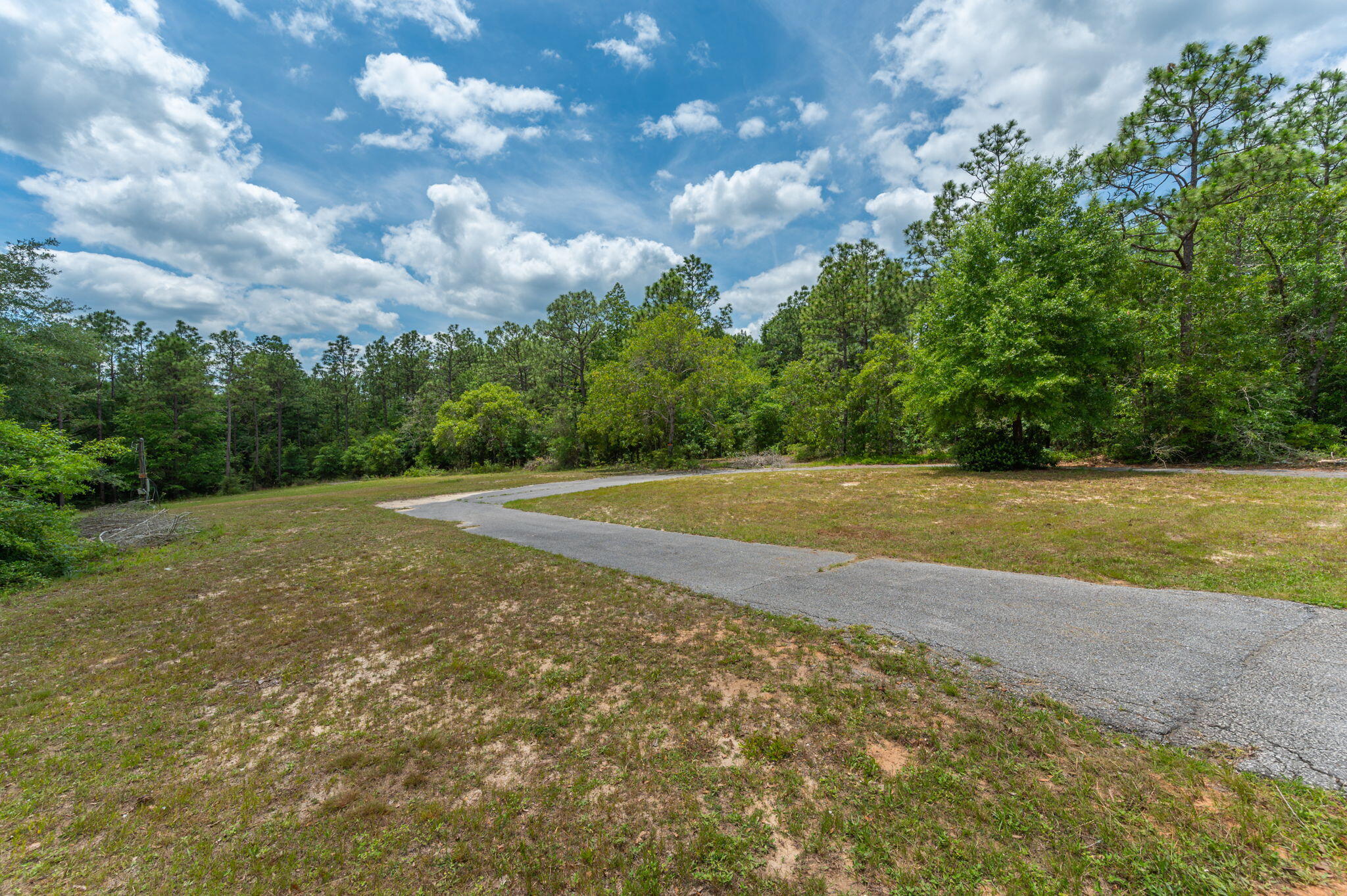 5710 Seminole Drive Crestview, FL 32536 - Photo 10 of 17 a view of a field with trees in the background