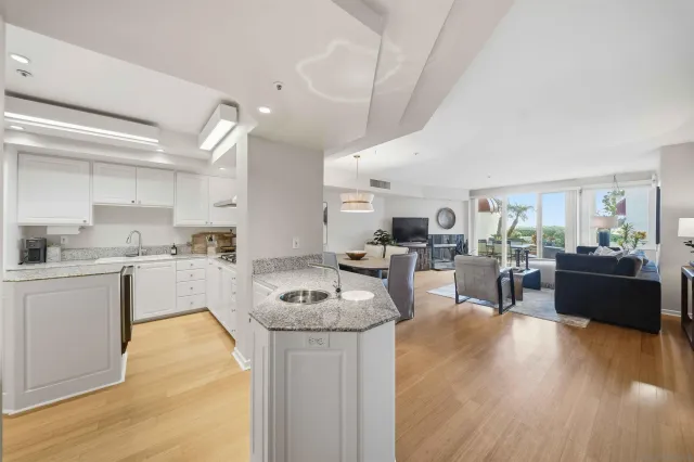 a kitchen with stainless steel appliances a sink stove and cabinets