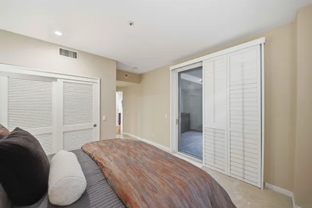 a bedroom with a walk in closet and chandelier