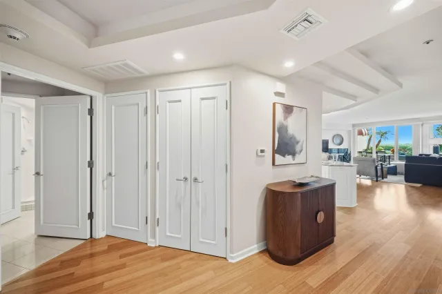 a view of an empty room with large windows and a table