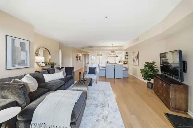 a view of kitchen with kitchen island a stove a wooden floor and a chandelier