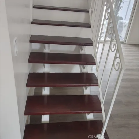 a kitchen with stainless steel appliances granite countertop a refrigerator a stove and white cabinets