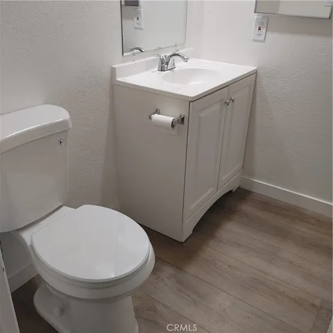 a white toilet and tub sitting next to a bathroom sink