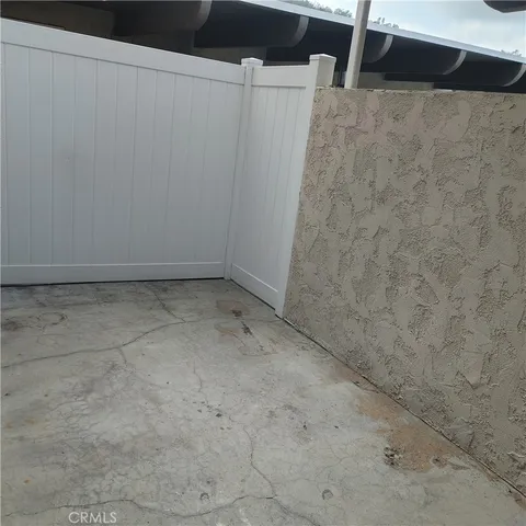a view of a hallway with wooden floor and windows