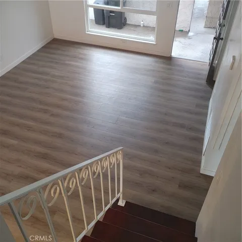 a kitchen with granite countertop white cabinets and stainless steel appliances