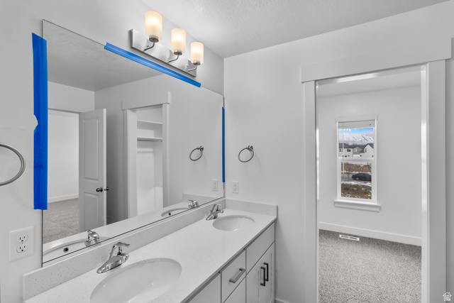 3014 South 265th Street West Logan, UT 84321 - Photo 24 of 25 Double vanity with integrated sinks, chrome faucets, and a light-toned countertop