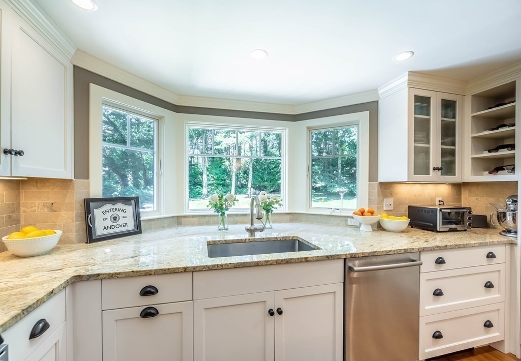 1 Rennie Drive Andover, MA 01810 - Photo 3 of 39 a kitchen with granite countertop kitchen island a window a sink and cabinets