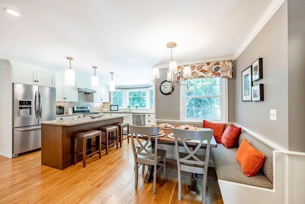 1 Rennie Drive Andover, MA 01810 - Photo 8 of 39 a view of a dining room with furniture a chandelier and wooden floor