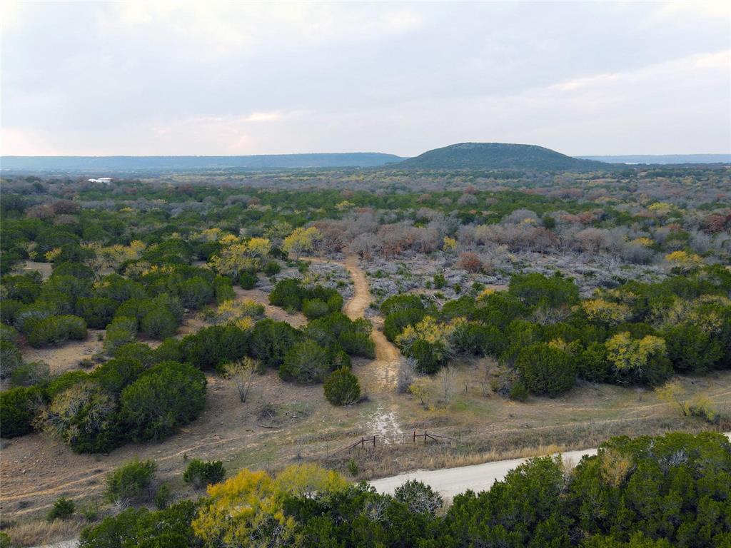 471 County Road 471 Strawn, TX 76475 - Photo 13 of 23 an aerial view of a houses with a yard and mountain view in back