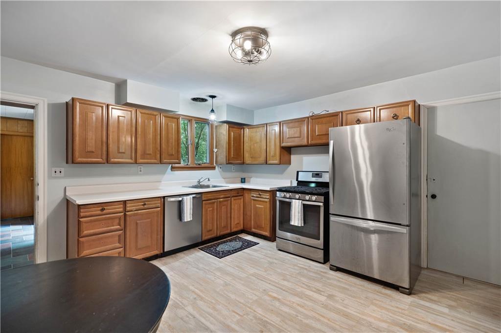 720 Perry Highway Pittsburgh, PA 15229 - Photo 13 of 39 a kitchen with granite countertop a refrigerator stove top oven and sink