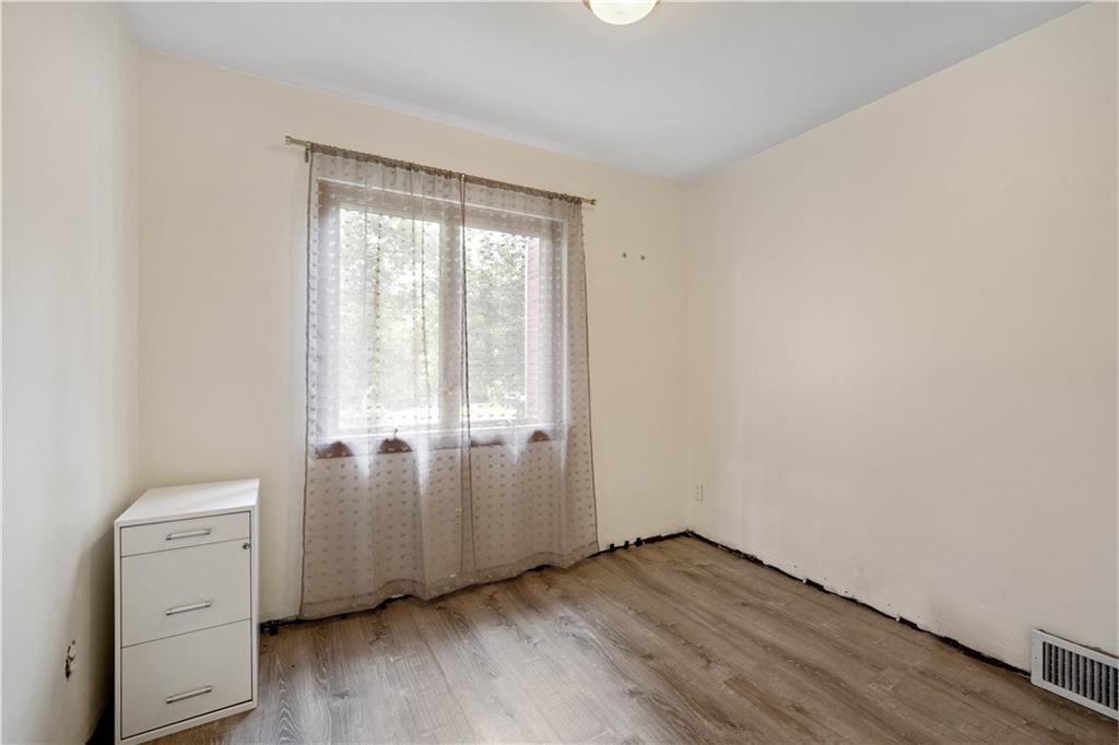 720 Perry Highway Pittsburgh, PA 15229 - Photo 26 of 39 an empty room with wooden floor and cabinet